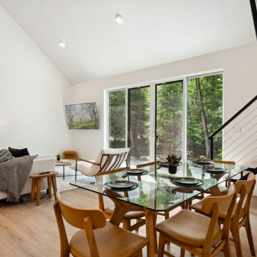With seating for eight and surrounded by trees, this glass-top dining table invites laughter, conversation, and Door County takeout nights.