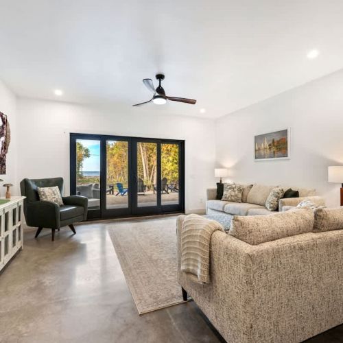 e open-concept living space is perfect for gathering after a day of exploring. With high-end finishes, comfortable seating, and large windows that frame the surrounding woods, this space invites you to unwind. Whether you're watching your favorite sh