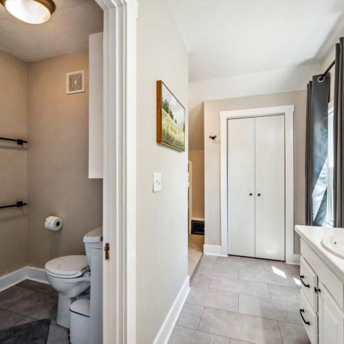 Indulge in the luxurious upper-level main bedroom bathroom, featuring a relaxing jetted tub and modern vanity. The stylish design and ample natural light create a spa-like retreat.