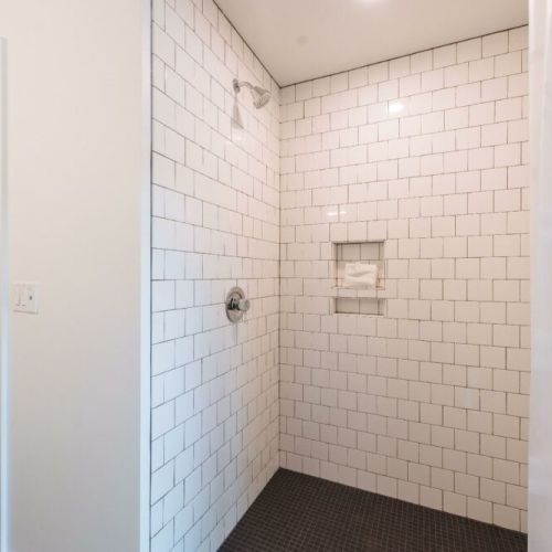 There are a total of 2 bathrooms.  Each bathroom features a double vanity and tile shower.