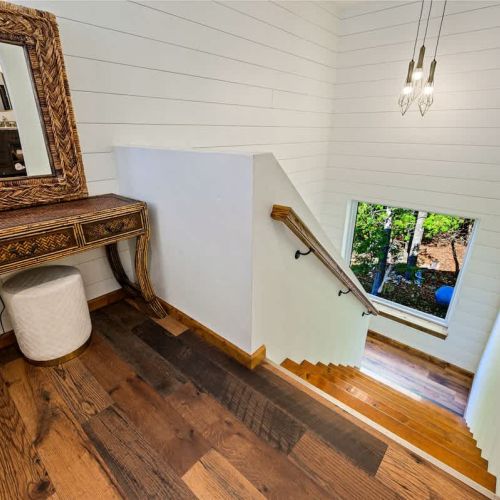 Staircase off the main living area leading up to 2 bedrooms and 2 bathrooms