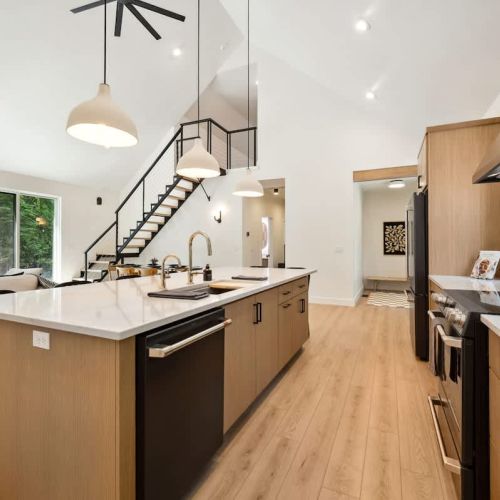 This high-end chef’s kitchen features GE Café appliances, All-Clad cookware, and a spacious island perfect for cooking together or catching up over wine.
