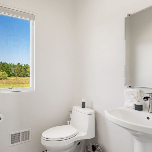 Half-bathroom located off the dining, kitchen and movie theater.