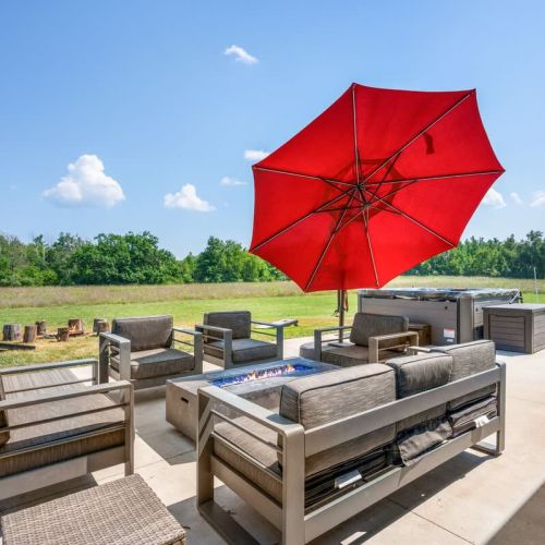 Step out to the expansive backyard patio, where outdoor living comes to life. Enjoy the relaxing hot tub, outdoor dining, cozy furniture with a fire table, a fire pit, and even a game of cornhole.