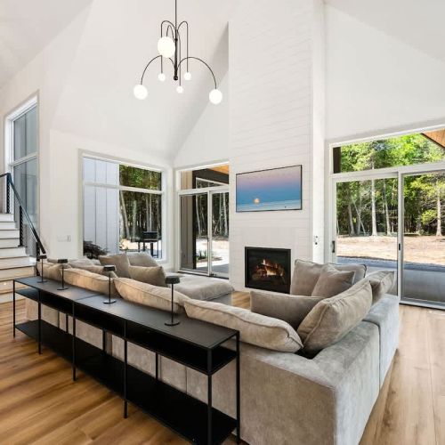Cozy up and connect. With a modular couch, electric fireplace, and Smart TV, this living space is made for group hangs and relaxing nights in.