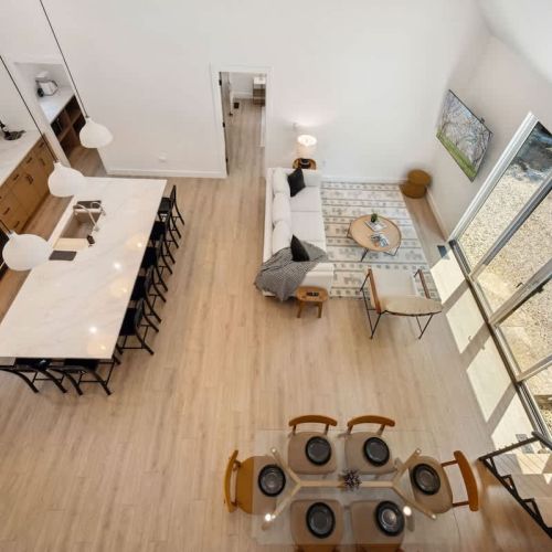 From the sleek dining setup to the expansive kitchen island and cozy lounge area, everything flows together for effortless comfort.