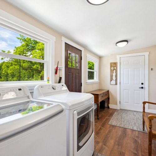 Enjoy the convenience of an updated laundry room featuring modern appliances, ample counter space, and plenty of natural light. The practical layout and additional storage make laundry tasks a breeze.