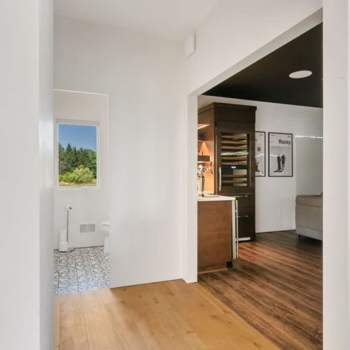 From the dining space, step into the dedicated entertaining wing—complete with a half bath, intimate movie theater with bar, and panoramic views of the prairie landscape.