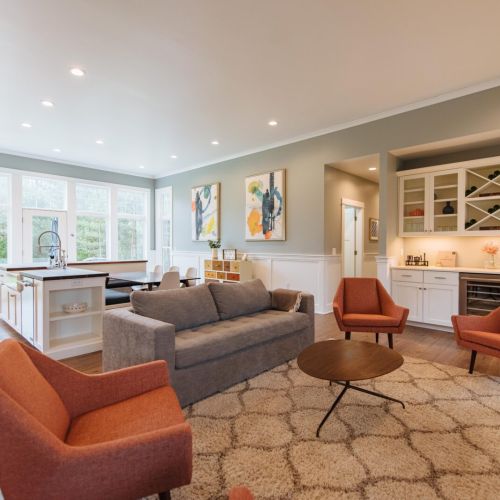 Unwind in Style: Spacious living area with contemporary flair, featuring plush seating and large windows that frame the serene Door County landscape. Perfect for family gatherings or a quiet retreat, this space invites you to relax and savor the comfort of our beautifully designed home in Egg Harbor.