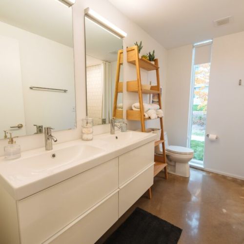 There are a total of 4 bathrooms (2 in each Flat).  Each bathroom features a double vanity and tile shower.
