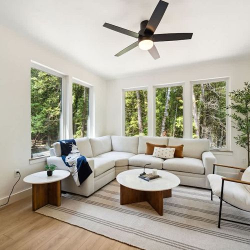 Surrounded by floor-to-ceiling windows, the four-season sunroom is the heart of the home. Enjoy the forest from the comfort of your plush sectional.