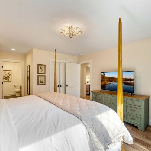 The primary suite features a king bed, smart TV, room-darkening shades, and a newly updated ensuite bathroom.