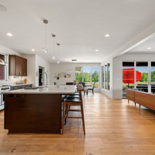 The expansive island provides additional seating and serves as the perfect centerpiece for cooking, entertaining, and connecting.