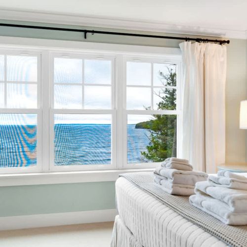 Upstairs, the master suite features a king bed with stunning bay views.