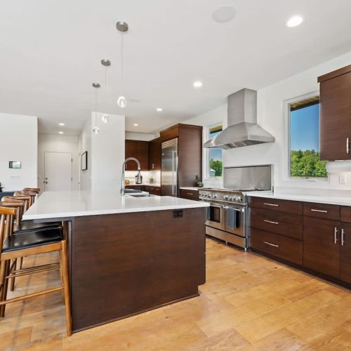 A well-appointed chef’s kitchen awaits, featuring a coffee bar, pantry, and adjacent mudroom with laundry.