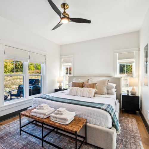 Just off the main living area, you'll find a luxurious master suite featuring a plush king-sized bed and a spa-like bathroom with a relaxing rainfall shower.