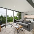 Enjoy open-concept living with sleek finishes, a cozy lounge space, and wall-to-wall views of nature.