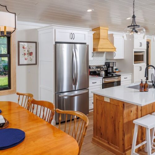 The modern kitchen is fully equipped, with dining for six plus additional breakfast bar seating.
