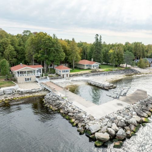 Discover the ultimate group getaway at Three Leaves Bayside Retreat in Egg Harbor, Wisconsin. Perfect for large families and reunions, this unique property features four charming cabins, a communal kitchen and mess hall, sauna and stunning waterfront views.