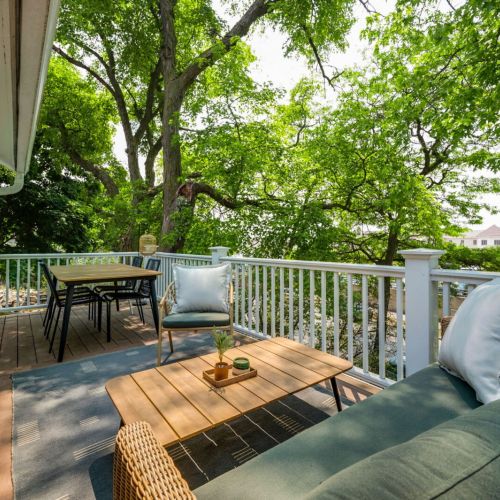 Behold the serene private veranda of the Magnolia Suite. Set against the lush backdrop of the backyard, this oasis is adorned with comfortable, stylish outdoor furniture, inviting you to unwind or dine in the open air. The inviting setup creates the perfect spot for alfresco dining or savoring a quiet moment while basking in the tranquility of the surroundings.