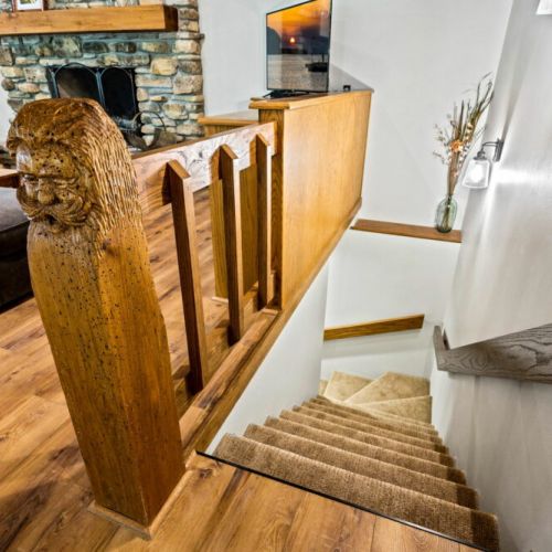 Staircase leading down to bunk room, laundry, converted game room and front entrance.