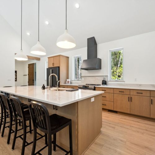 This high-end chef’s kitchen features GE Café appliances, All-Clad cookware, and a spacious island perfect for cooking together or catching up over wine.