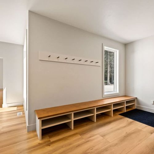 Off from the kitchen, a large mud-room offers plenty of storage for coats, bags and shoes.