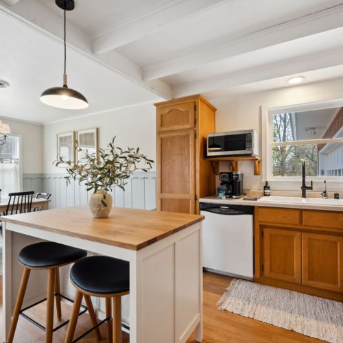 A sunny, fully equipped kitchen, featuring both a standard coffee maker and Keurig, dishwasher, microwave, toaster, and more-perfect for everything from morning pancakes to holiday dinners.