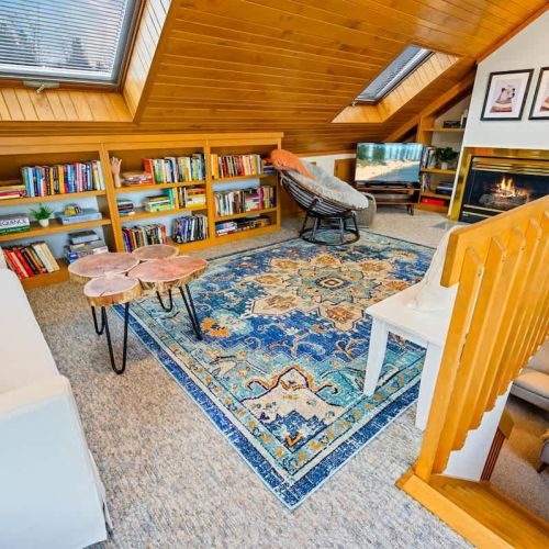 Ascend these warm wooden stairs to discover the secluded upper-level loft of Sandvik House.