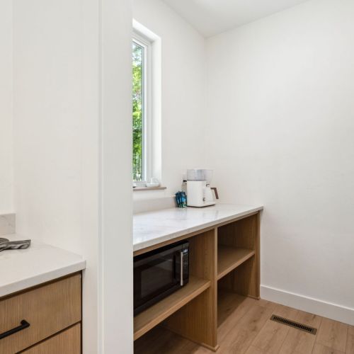 Tucked away just off the kitchen, this dedicated coffee bar and pantry is stocked with everything you need for slow starts and strong brews.