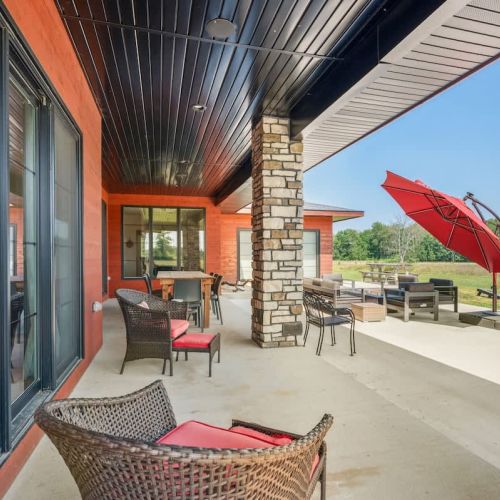 Step out to the expansive backyard patio, where outdoor living comes to life. Enjoy the relaxing hot tub, outdoor dining, cozy furniture with a fire table, a fire pit, and even a game of cornhole.