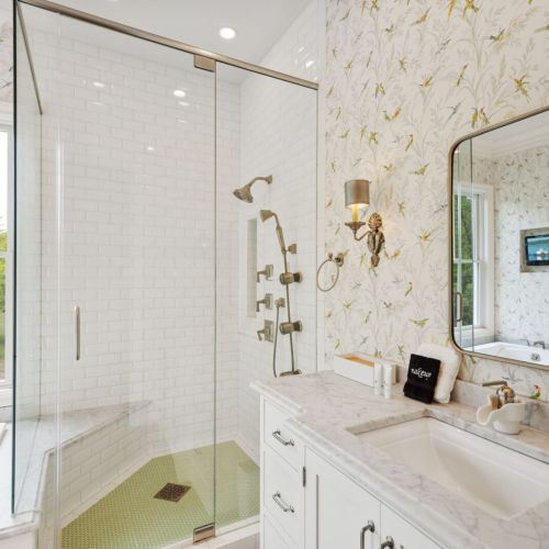 The master suite enhances the serene atmosphere, creating a spa-like oasis with a large soaking tub, a walk-in shower, and dual vanities offering ample space to get ready for the day.