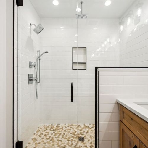 The brand new shower has a glass surround and three shower heads:  Classic, hand-held, and rainshower.
