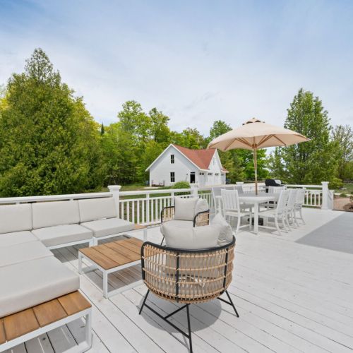 Step outside to discover the expansive outdoor space, designed for relaxation and enjoyment. The large deck is perfect for lounging or dining, offering panoramic views of the surrounding natural beauty