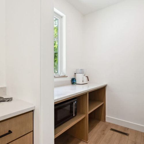 Tucked away just off the kitchen, this dedicated coffee bar and pantry is stocked with everything you need for slow starts and strong brews.