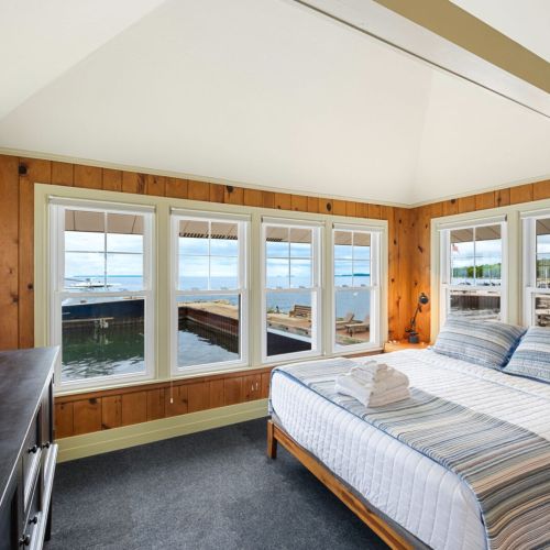 A comfortable queen bed overlooks the picturesque shoreline. Wake up to the sound of waves!