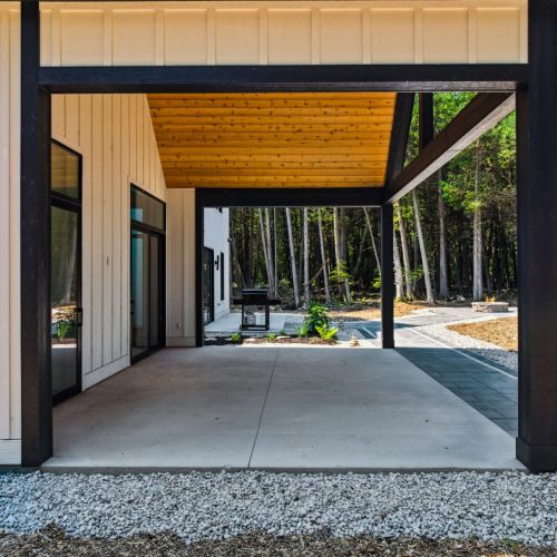 Outdoors, the expansive patio invites guests to relax under the trees, dine al fresco, or gather around the fire pit. With a barbecue grill, outdoor seating, and serene surroundings, it’s the perfect setting for reconnecting with friends and family.