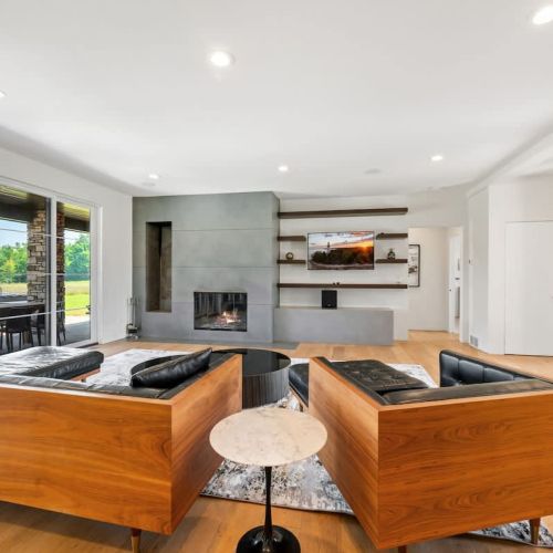 A spacious, modern open-concept living area brings everyone together, while a glowing fireplace and Smart TV create the perfect backdrop for relaxation and entertainment.