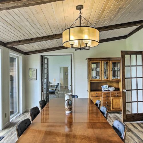 A spacious dining room directly off kitchen offers comfortable seating and opens up to an outdoor patio. Here, you can relish stunning vistas and easily access the outdoor barbecue for a delightful dining experience.