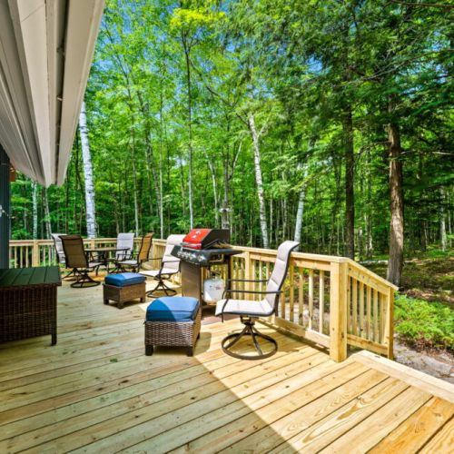 Step outside onto the wrap-around deck, complete with a grill, dining area, and comfortable lounge seating.