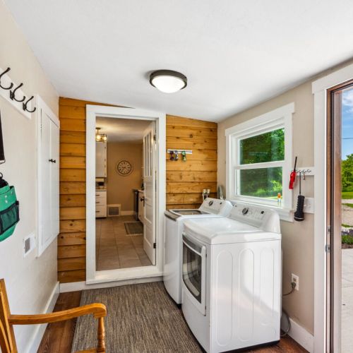 Enjoy the convenience of an updated laundry room featuring modern appliances, ample counter space, and plenty of natural light. The practical layout and additional storage make laundry tasks a breeze.