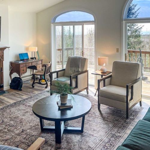 The second living area off of dining room offers abundant space for the entire group to unwind comfortably. You can also relish the warmth of a second fireplace and step out onto the wrap-around deck for even more relaxation and enjoyment.