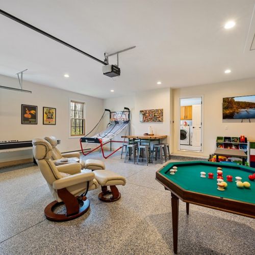 The garage is converted into a game room with baseboard heat, a smart TV, and fun for all ages - even on rainy days!