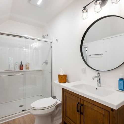 A full bathroom with a walk-in shower serves the upper level.