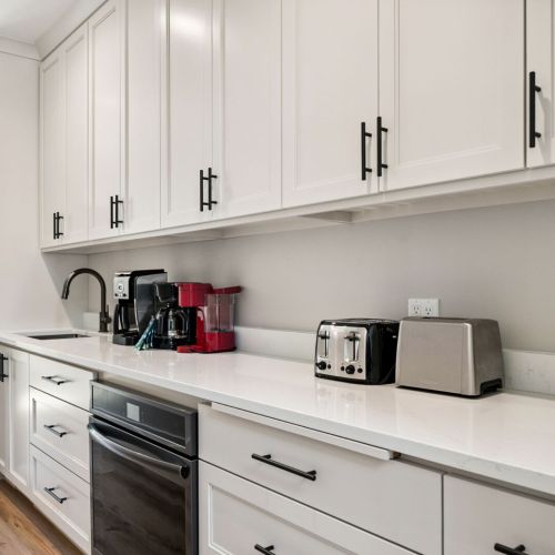 The butler's pantry acts as an additional food prep space, boasting a second fridge, oven, sink, and coffee bar.