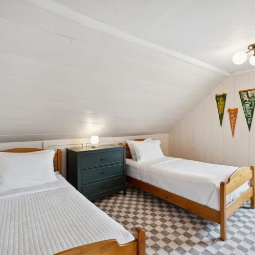The second bedroom features two twin-sized single beds and smart tv-perfect for kids, teens, and those young at heart.