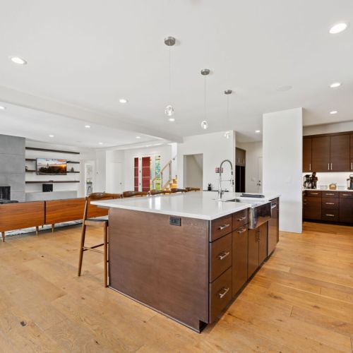 The expansive island provides additional seating and serves as the perfect centerpiece for cooking, entertaining, and connecting.