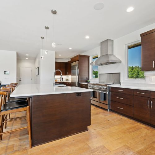 A well-appointed chef’s kitchen awaits, featuring a coffee bar, pantry, and adjacent mudroom with laundry.