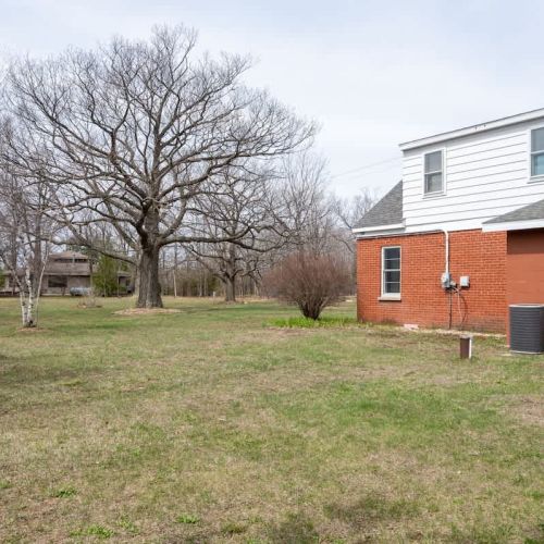 The large open yard offers space to run, play, and soak up the sun, while mature trees provide shade for relaxing from spring through fall.