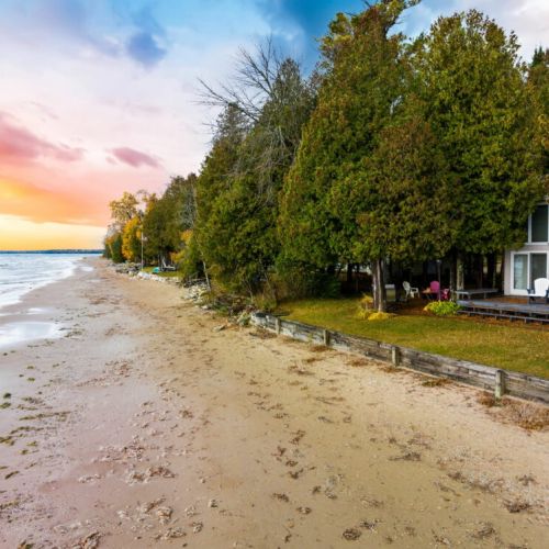 One of the standout features of this property is the sandy beach right out your back door. Build sandcastles with the kids, stroll along the shore, or kayak over to Cave Point County Park.
